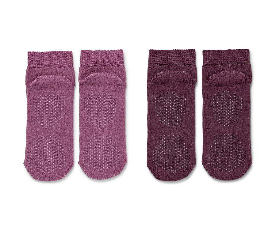 Zwei Paar Yogasocken in Rosé und Mauve.