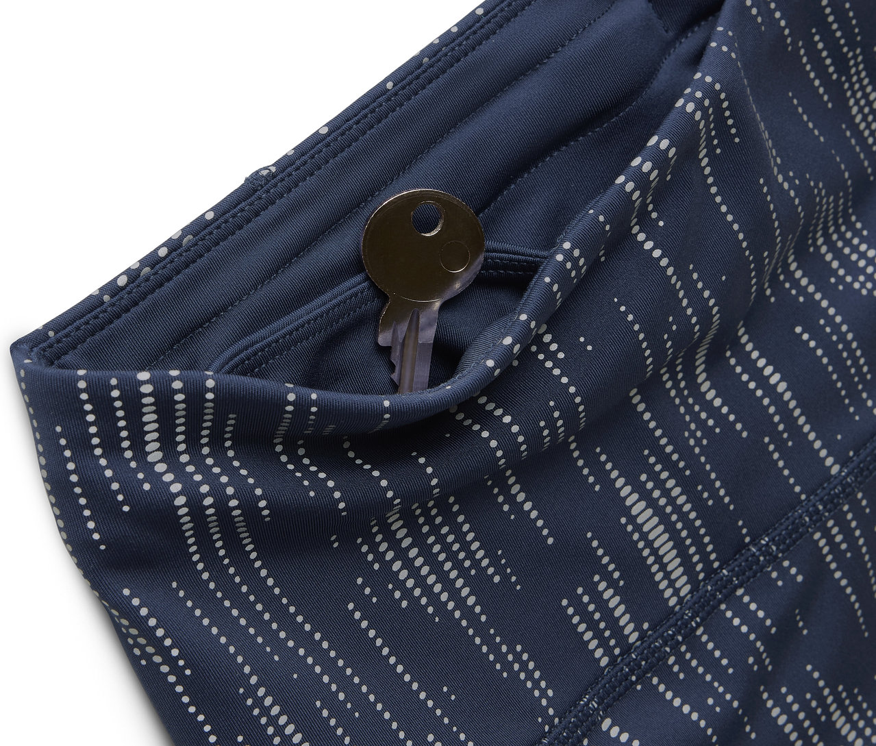 Detailaufnahme von blau gemusterten Leggings mit Schlüssel in der Tasche.