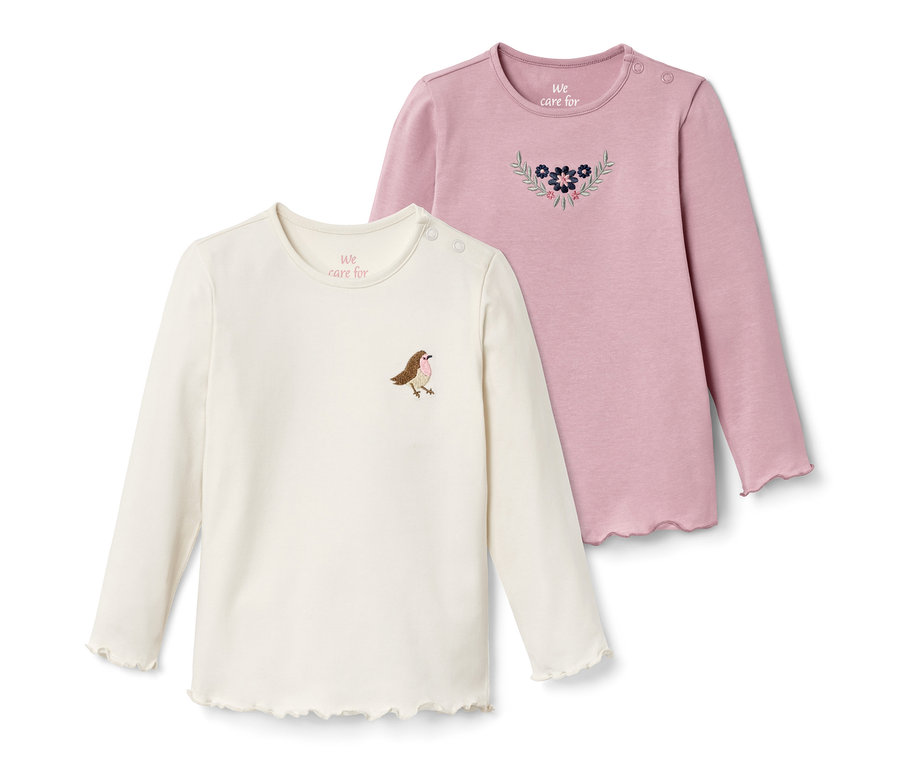 Zwei Langarmshirts, ein cremefarbenes mit Vogel, ein rosafarbenes mit Blumen.