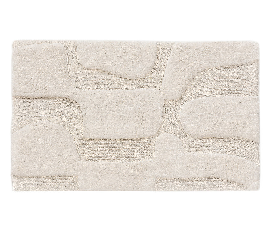 Ein rechteckiger, beiger Badvorleger mit erhabenem Muster.