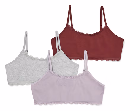 Drei Bralettes in Dunkelrot, Hellgrau und Helllila mit Spitzenbesatz an den Rändern.