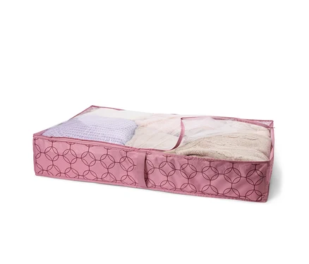 Rosa Unterbettkommode mit geometrischem Muster, gefüllt mit Textilien, unter einem transparenten Deckel.