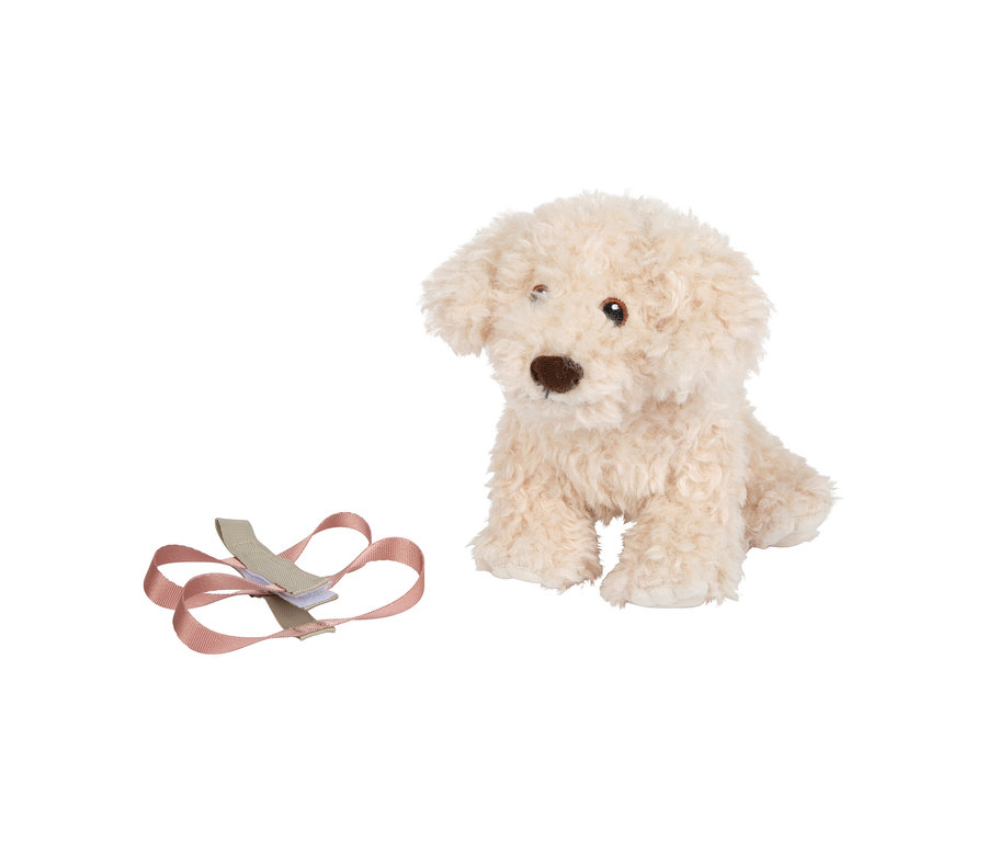 Cremefarbener Plüschhund sitzt neben einer rosa-beigen Leine.