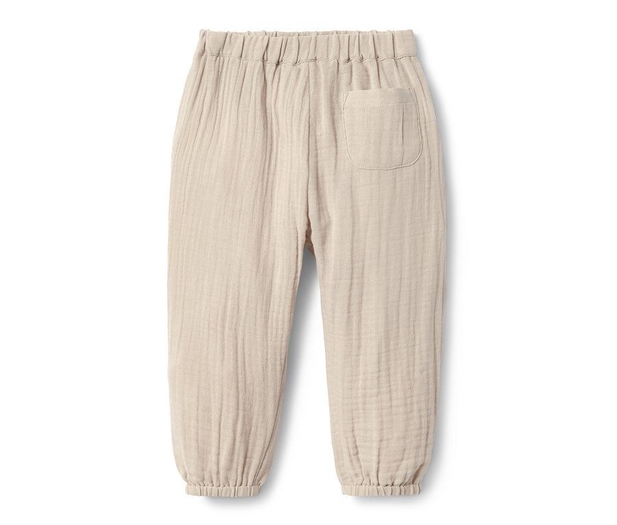 Beige Schlupfwebhose aus Bio-Baumwolle.