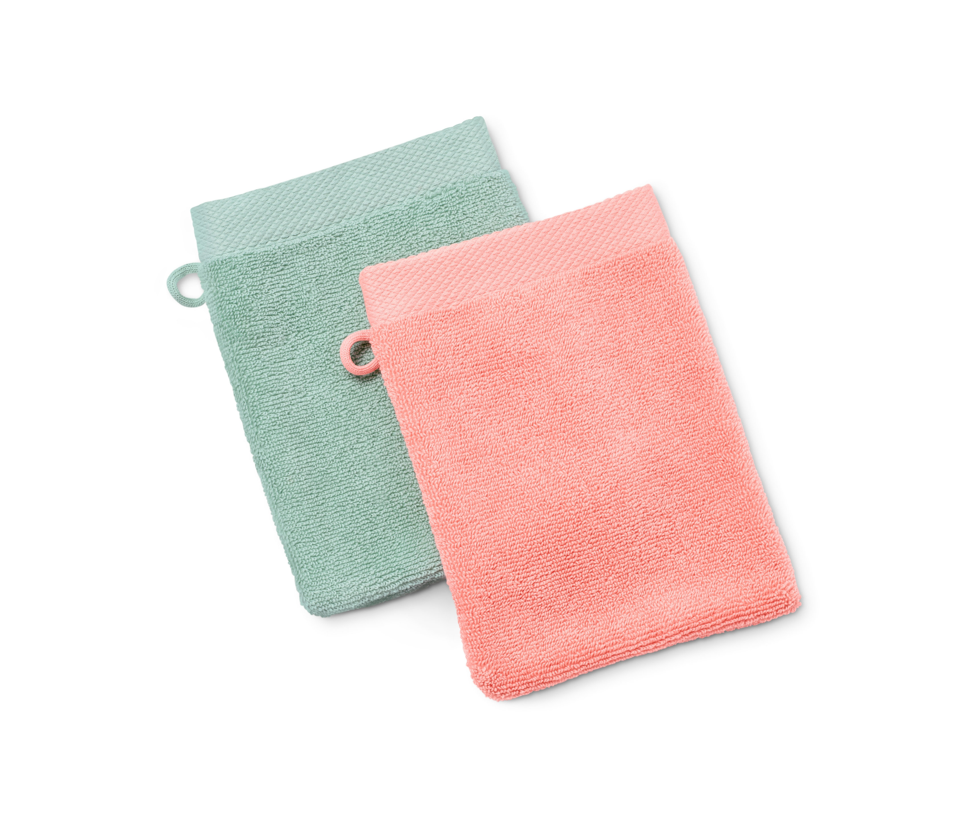 Zwei hochwertige Waschlappen, einer in Mint, einer in Pfirsich, liegen auf einem weißen Hintergrund.