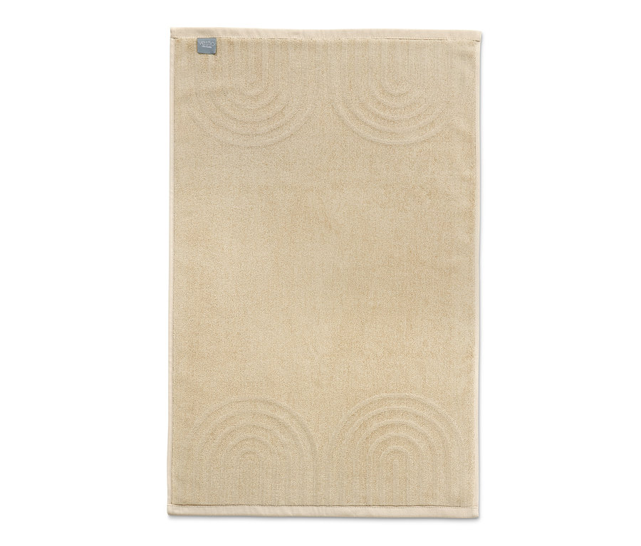 Cremefarbener Jacquard-Duschvorleger mit erhabenem Halbkreis-Muster.