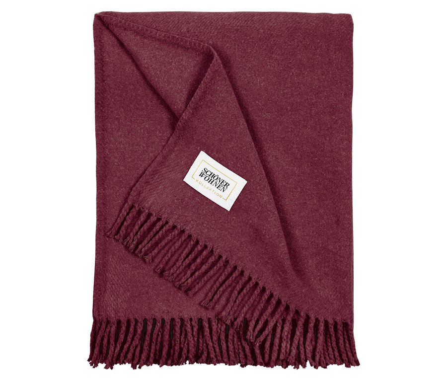 Burgunderrote Decke mit Fransen und weißem Etikett.