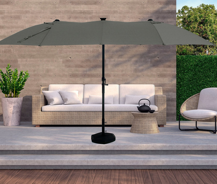 Terrasse mit LECO Doppel-Sonnenschirm* mit LED-Beleuchtung, oval, ca. 270 x 460 cm, anthrazit über einer Couch.