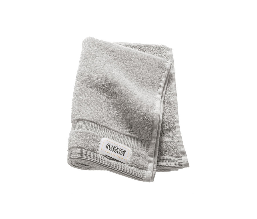 Ein gefaltetes, hellgraues Gästehandtuch der SCHÖNER WOHNEN-Kollektion Cuddly.
