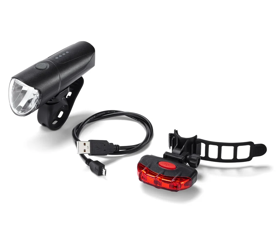 Schwarzes Fahrrad-Beleuchtungs-Set mit USB-Kabel auf weißem Hintergrund.