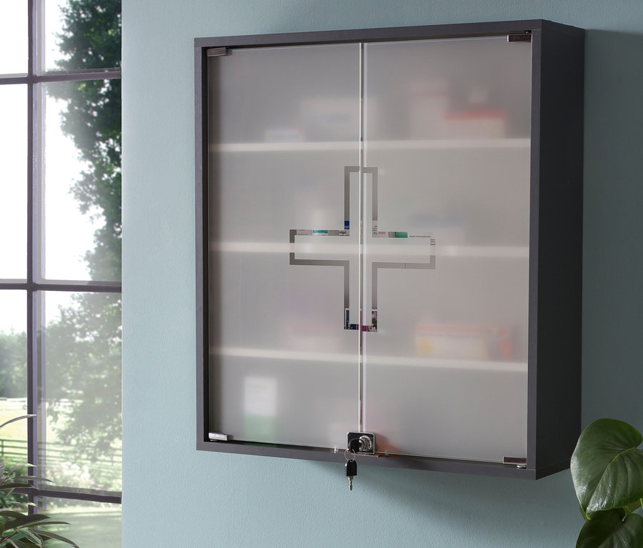 Anthrazitfarbener Medikamentenschrank »Wido« hängt an Wand neben Tisch mit Pflanzen.