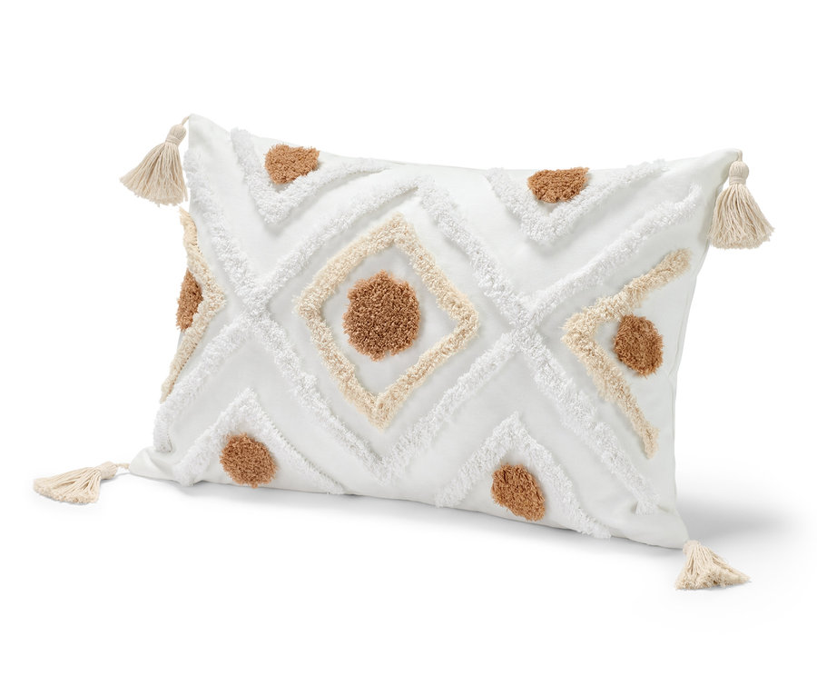 Ein Dekokissen, ca. 40 x 60 cm, in Weiß mit braunen und weißen Mustern und Quasten an den Ecken.