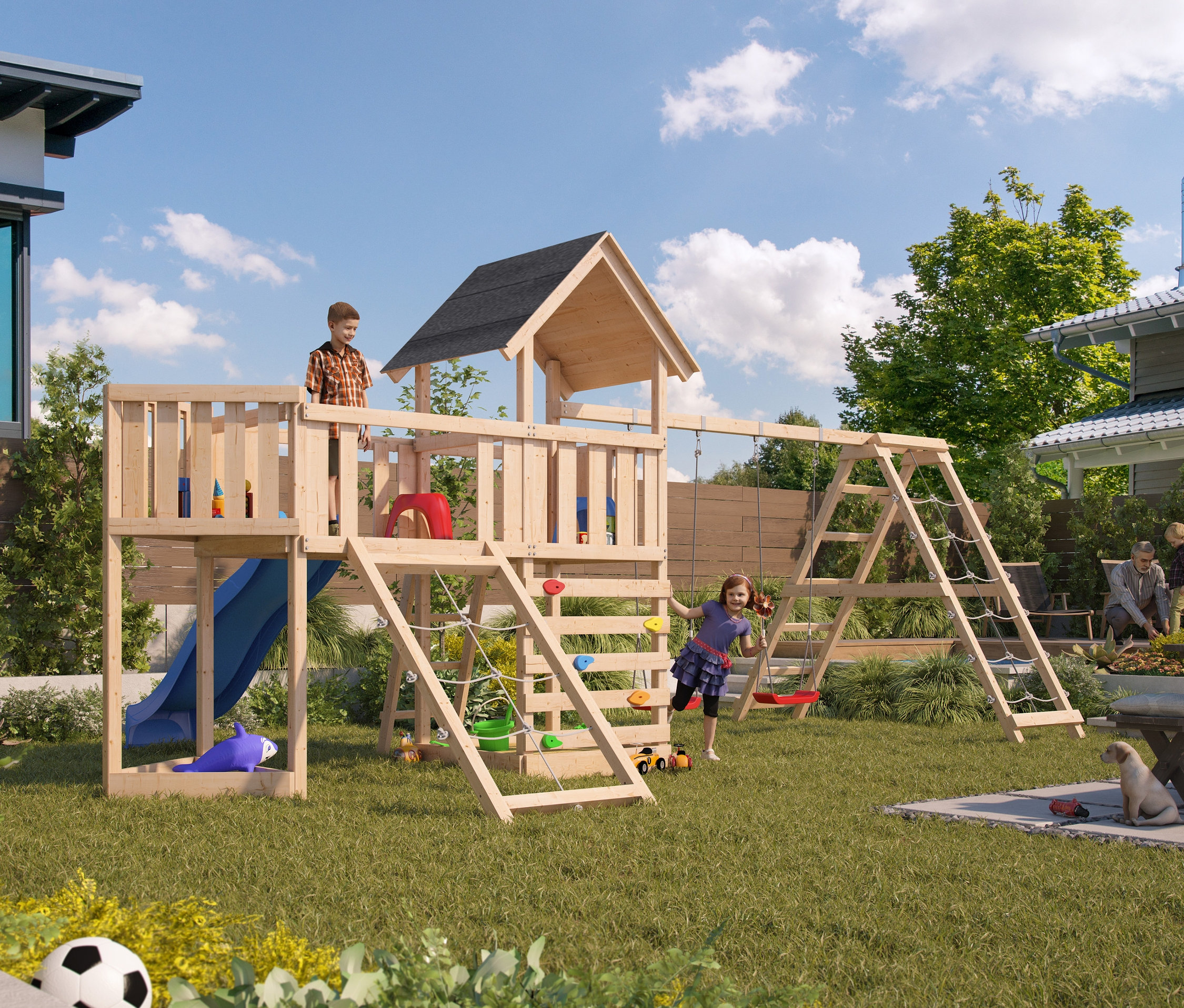 Ein Junge steht auf dem Karibu Kinderspielturm-Mega-Set "Lotti" mit Doppelschaukel, Rutsche, Anbauplattform und Klettergerüst, während ein Mädchen auf der Schaukel spielt.