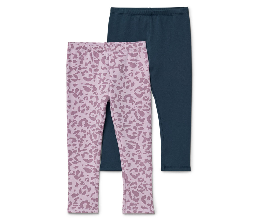 Zwei Leggings, eine dunkelblaue und eine hellrosa mit Leopardenmuster, liegen übereinander.