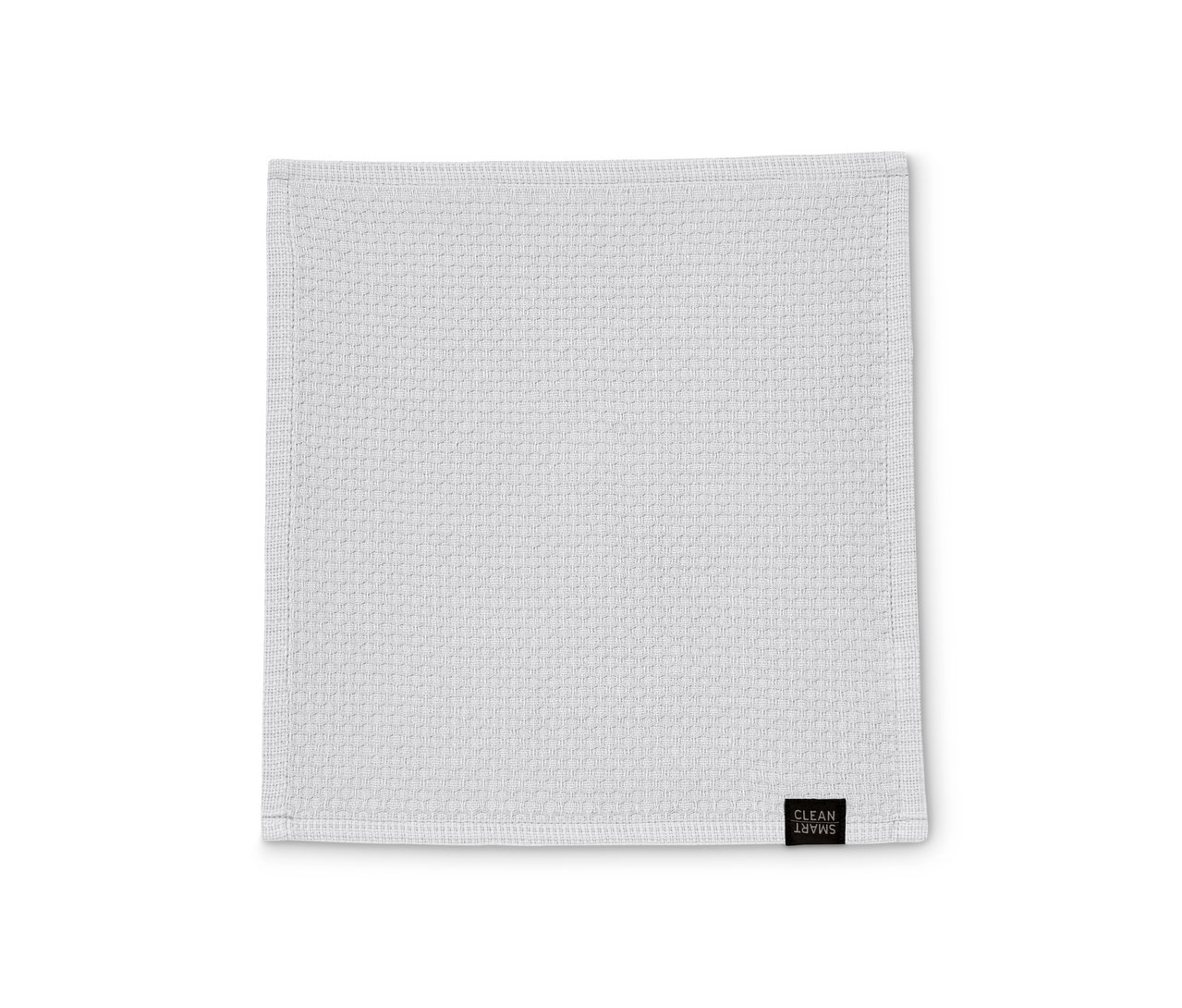 Ein einzelnes weißes 3 Spültuch liegt flach auf einer weißen Oberfläche.