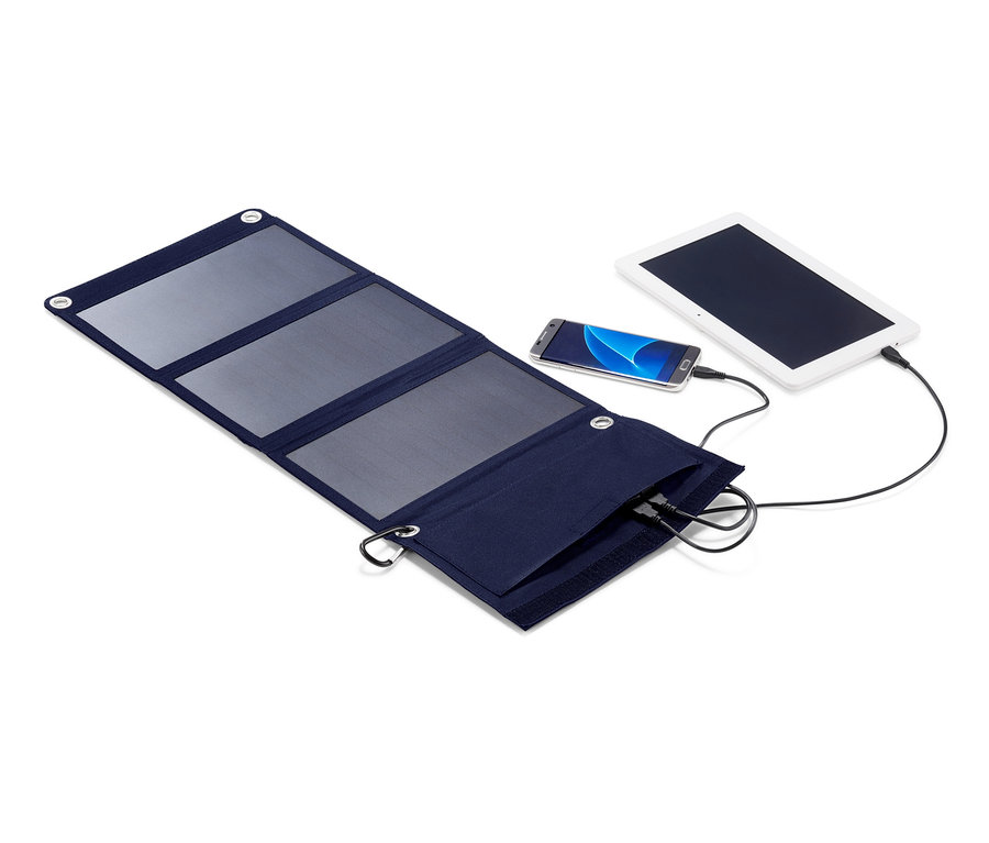 Ein aufgefaltetes, faltbares Solar-Ladegerät lädt ein Tablet und ein Handy auf.