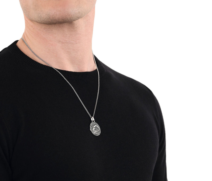 Mann trägt eine silberne Halskette mit einem ovalen Anhänger mit einem Wellenmuster.