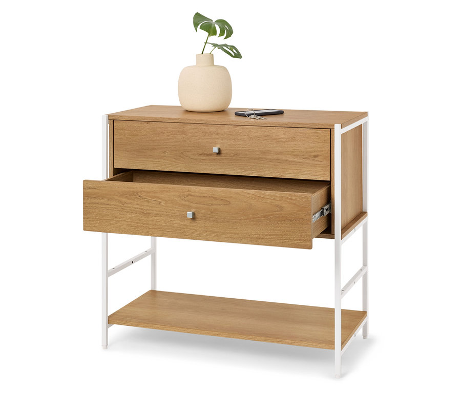 Kommode aus hellem Holz mit zwei Schubladen, von denen eine geöffnet ist, und einem weißen Metallrahmen. Oben steht eine Vase mit einer grünen Pflanze.