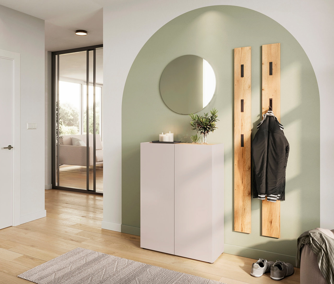 Flur mit weißem Schuhschrank, Spiegel, Holzgarderobe und Jacke vor mintgrüner Wand.