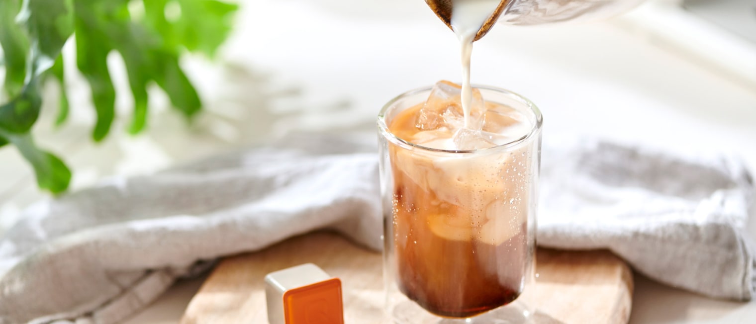 Milch wird in ein Glas Kaffee eingeschenkt','Enter picture alt'}