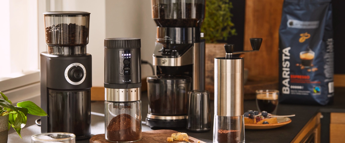 Mann schaut in eine Dose mit frisch gemahlenem Kaffee