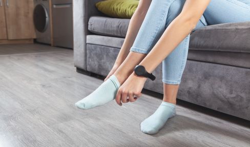 Das A und O beim Sockenkauf: eine Frau zieht sich ihre Sneaker Socken an.